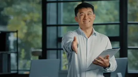 Smiling professional extending a hand in greeting