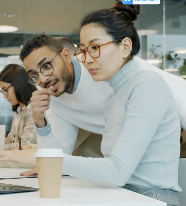 Engineers and colleagues working together at a desk